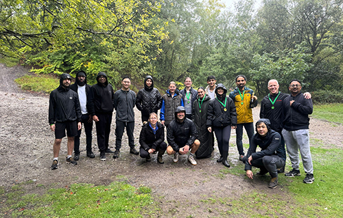 Team members stood outdoors in coats
