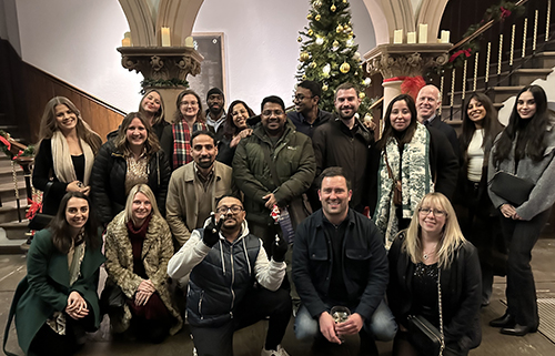Emrise team stood in front of christmas tree
