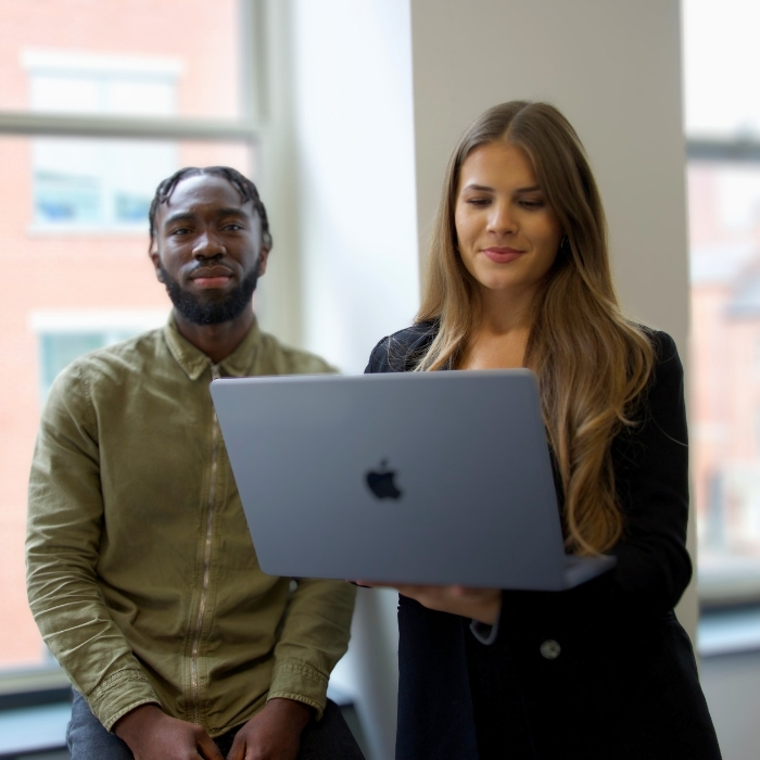 Two people looking at laptop