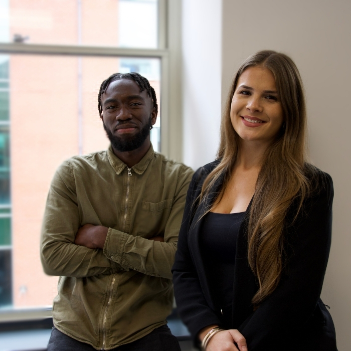 Male-and-female-standing-next-to-each-other-smiling