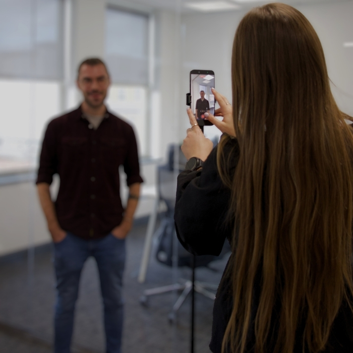 Person filming another person on a phone