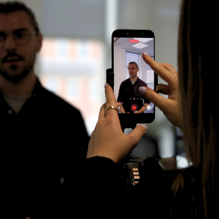 Close up of phone screen where someone is being filmed