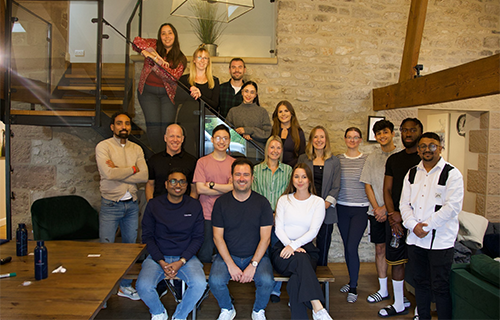 Emrise team stood on and in front of stairs